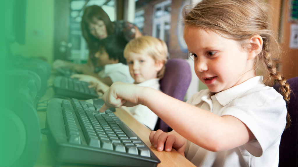 Young girl on computer pressing keyboard